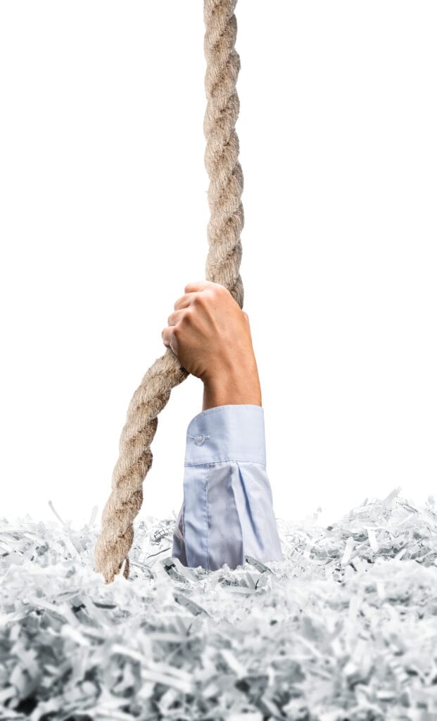 Shredding A Rope Stretches hand from white shredded papers - MetroShred
